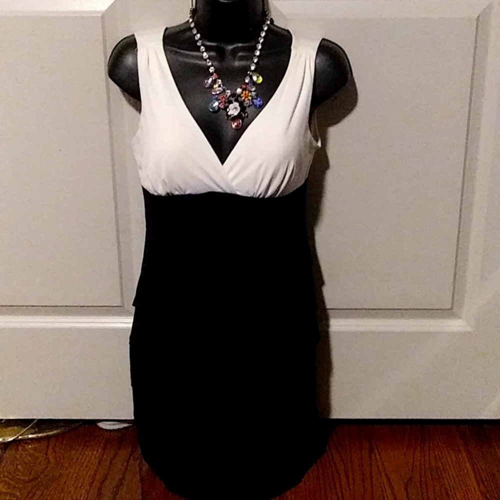 A black and white cocktail dress .